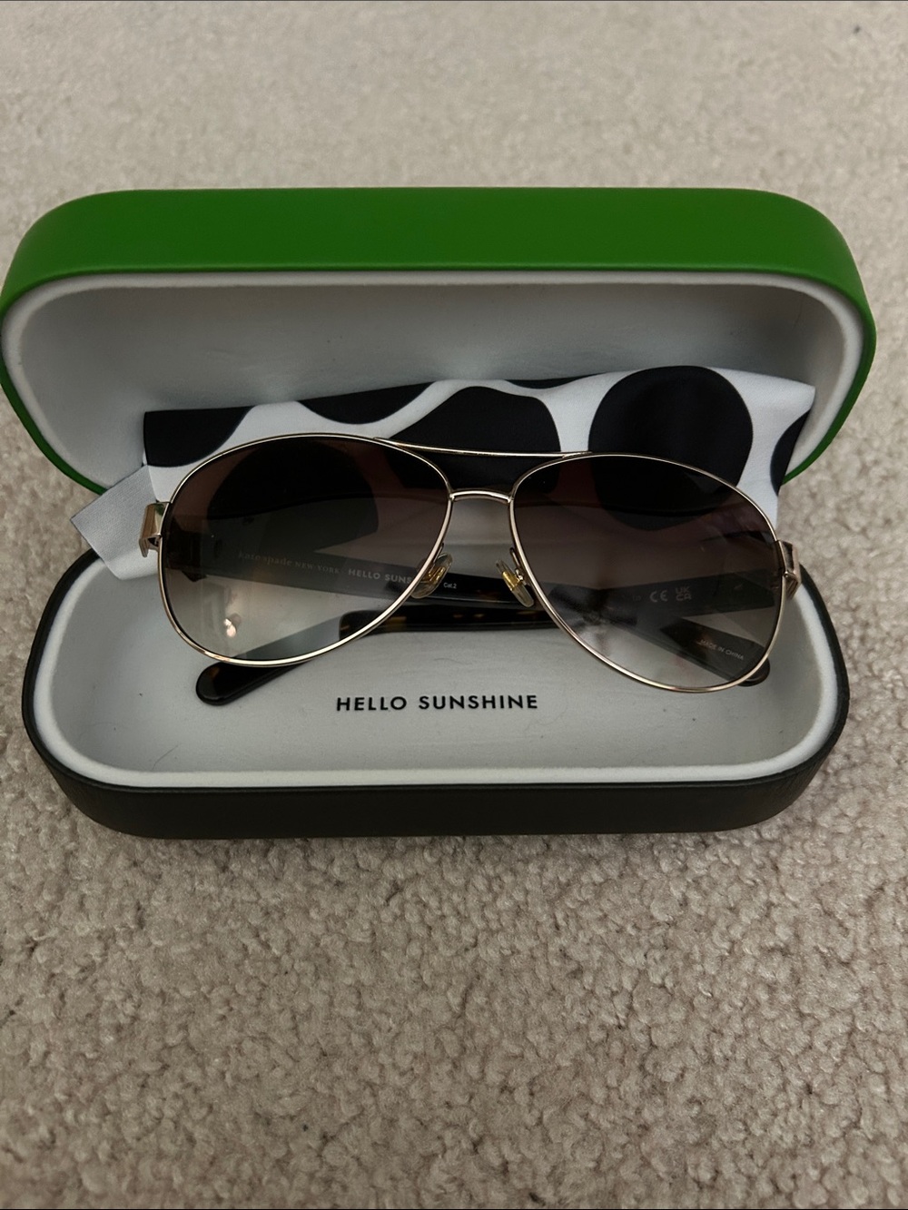 Kate Spade Aviator Sunglasses with Gold Frame and Brown Gradient Lenses.